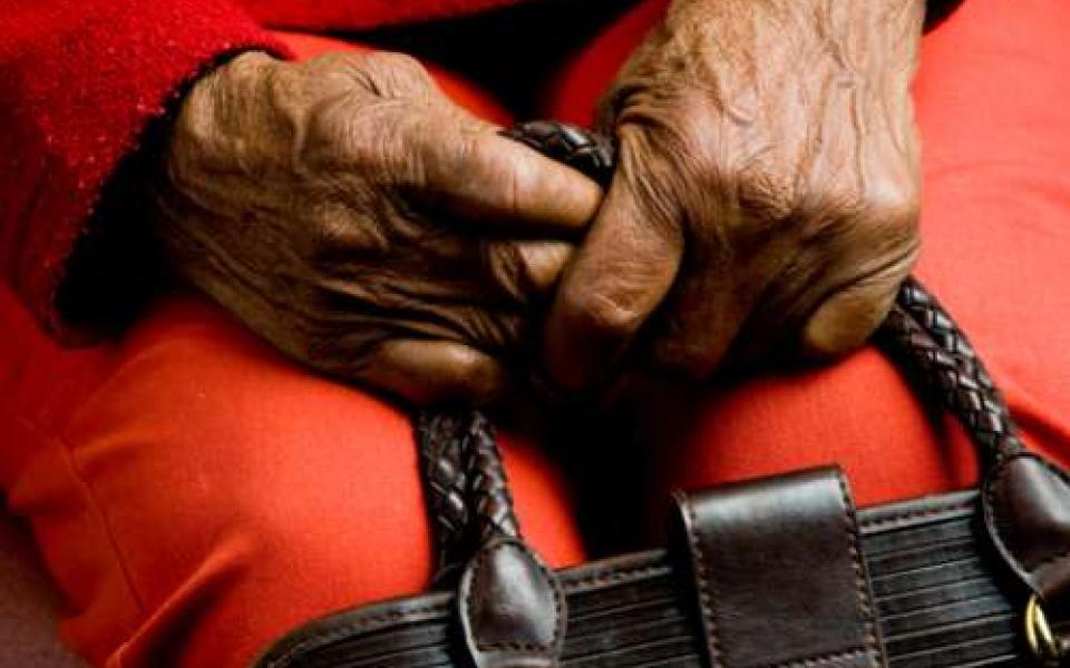 Elderly woman holding her purse