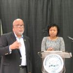 Congressman Bennie Thompson at podium with a woman