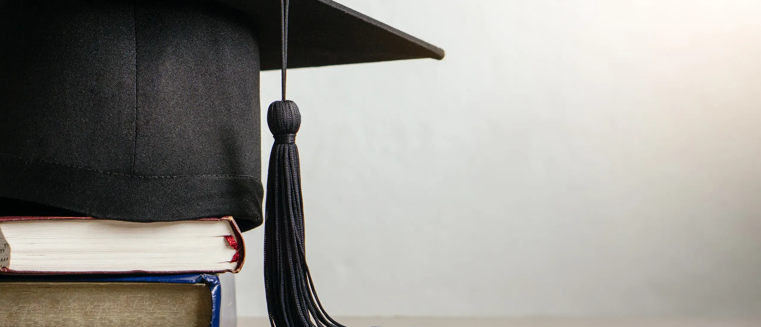 Graduation cap and books